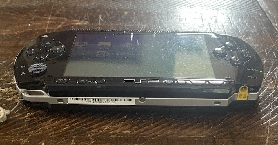 Sony PSP-1001 Console, 2 Batteries w/Charger, 4 Games, 2 Movies, Family Guy 1&2
