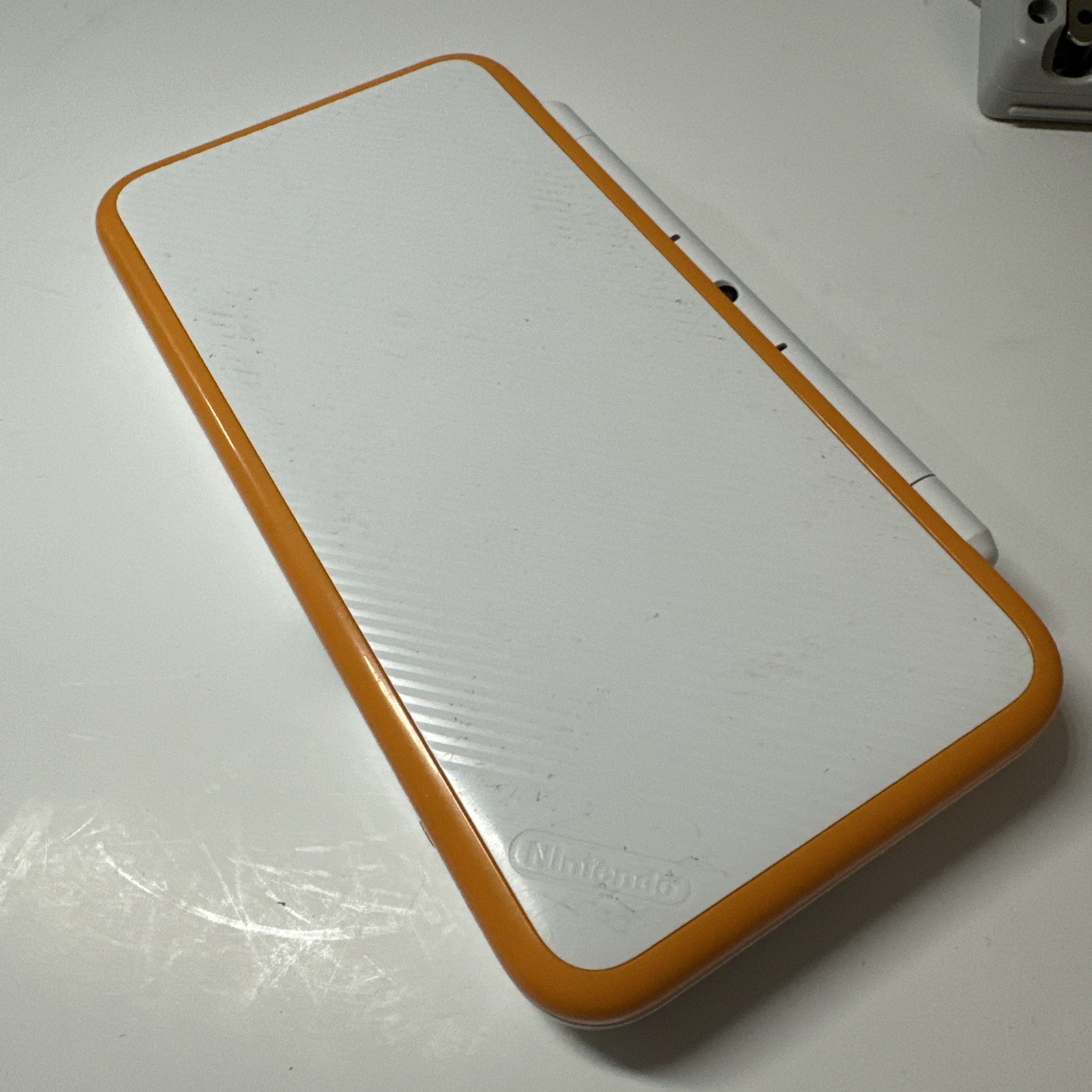 Nintendo 2DS XL – Orange & White Bundle (Top Screen Crack/ Non-OEM Charger)