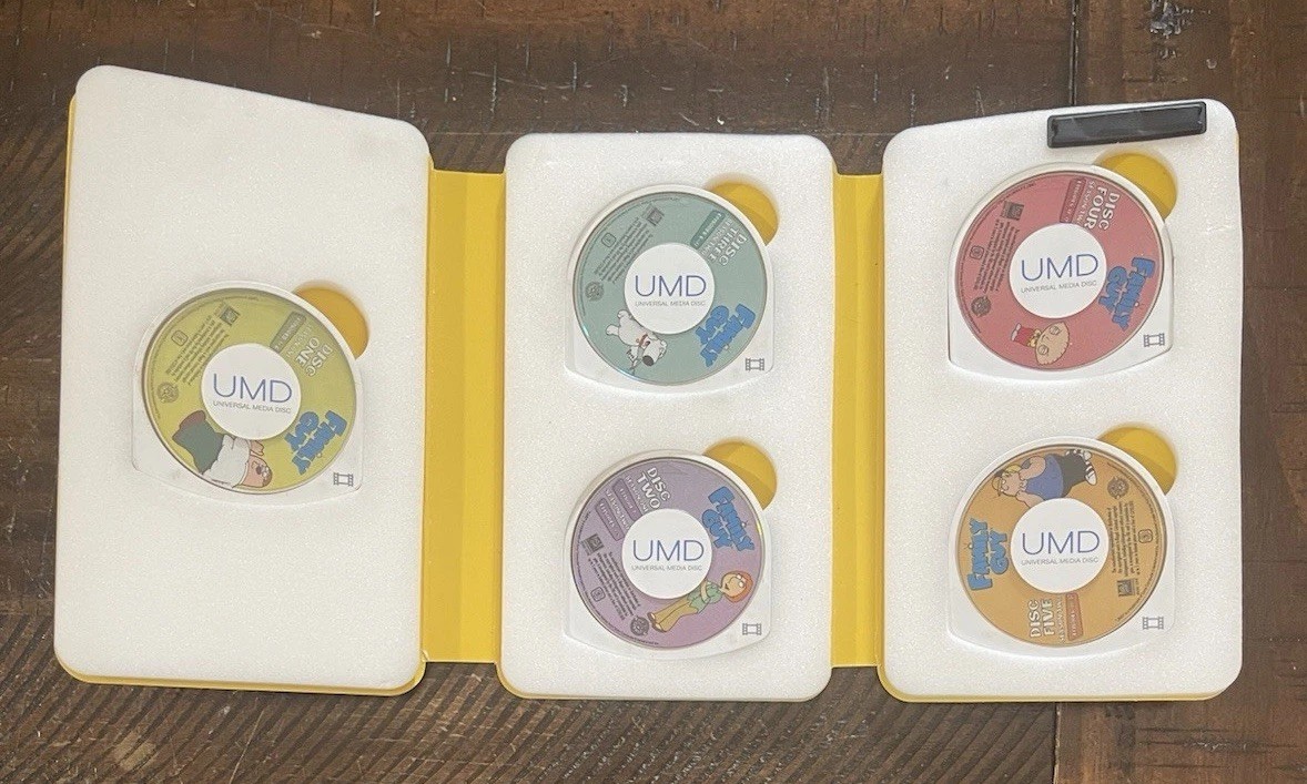 Sony PSP-1001 Console, 2 Batteries w/Charger, 4 Games, 2 Movies, Family Guy 1&2