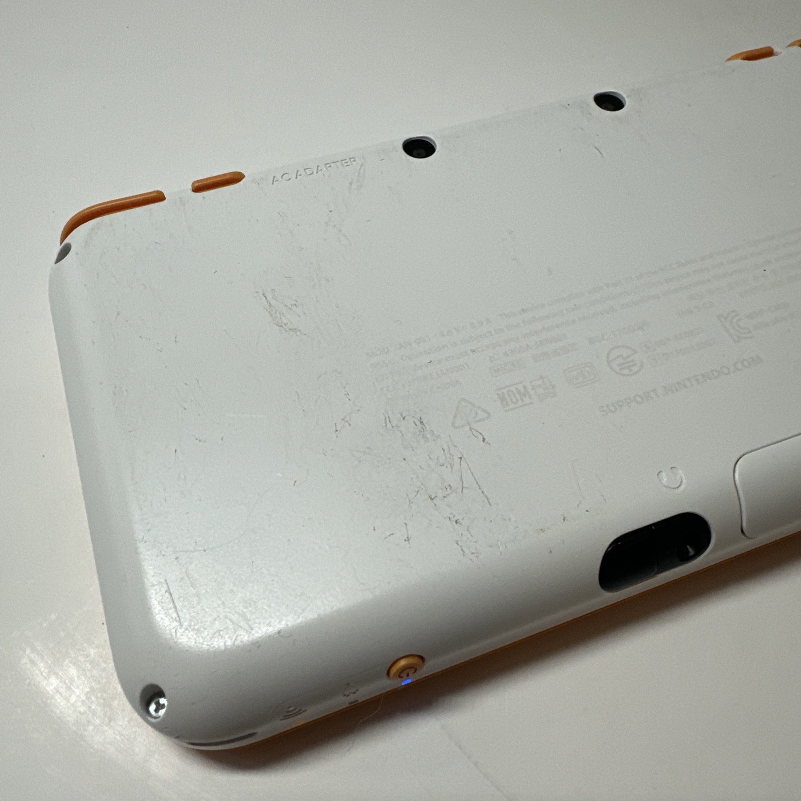 Nintendo 2DS XL – Orange & White Bundle (Top Screen Crack/ Non-OEM Charger)